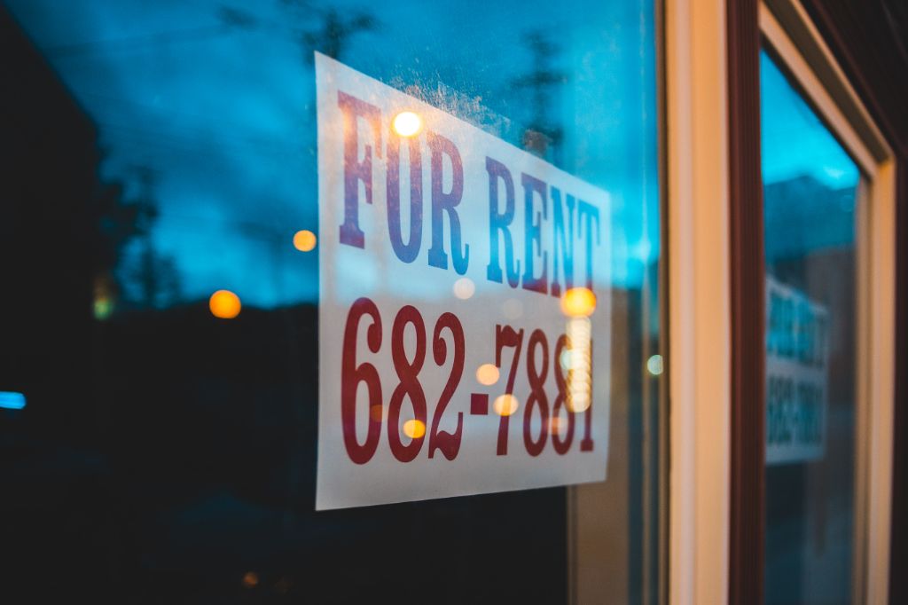 For rent sign and a phone number, representing renting out a spare room for extra income