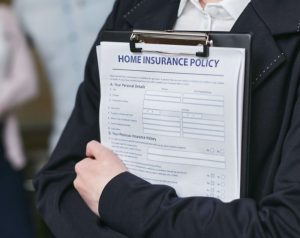 Man holding a home insurance policy