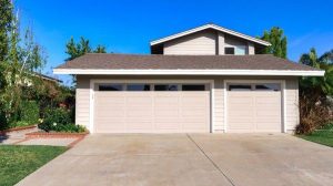 An exterior of a gray house with double garage doors